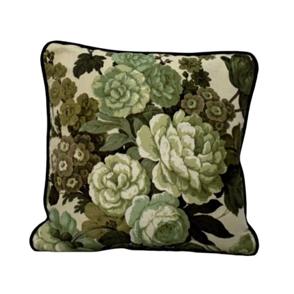 Floral-patterned pillow on a white surface with a neutral background, sea foam back