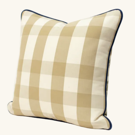 Beige checkered pillow with black trim verso of nature themed face