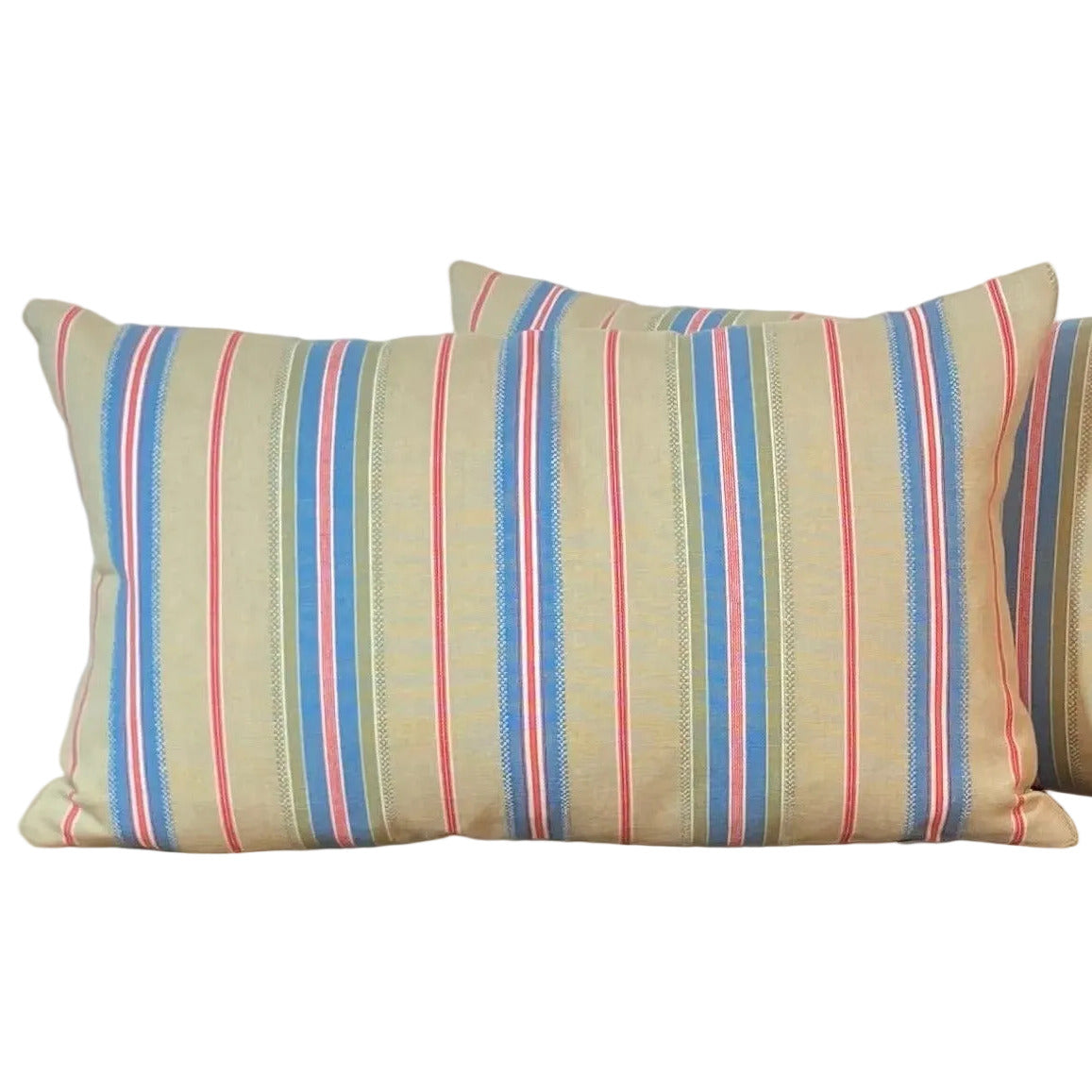 Striped lumbar cushion with a green neutral background blue red and white stripes.