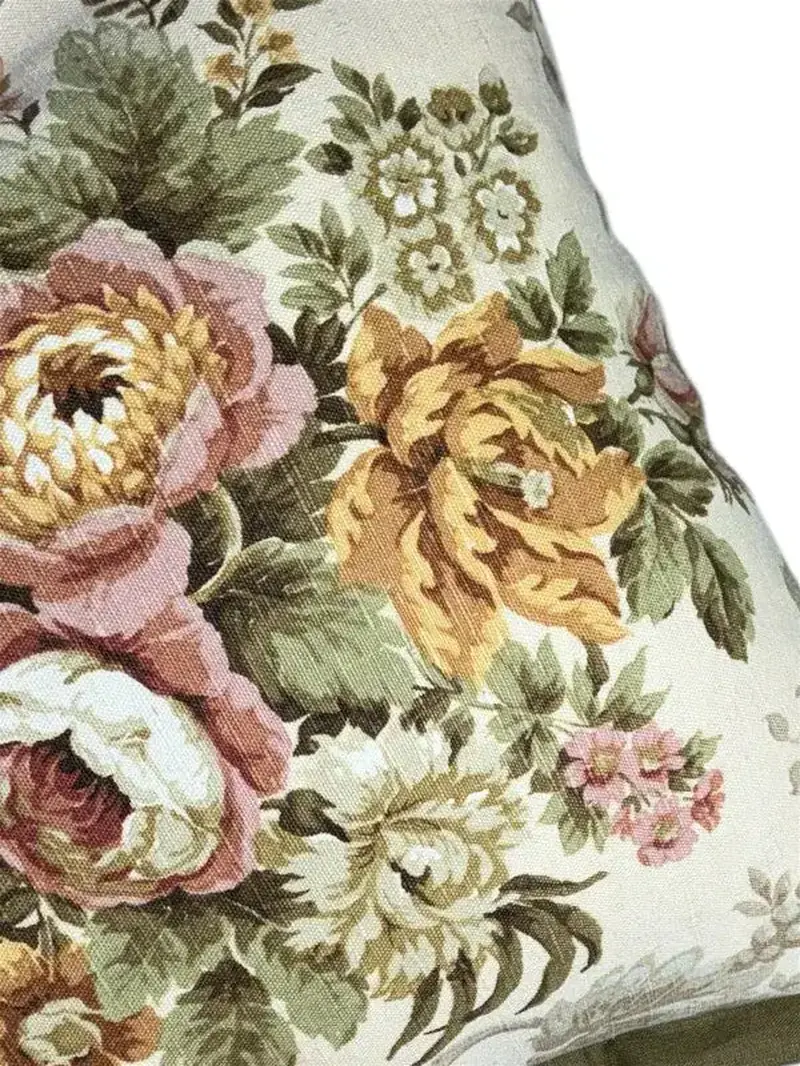 Close-up of vintage floral cushion fabric in dusty rose and sage tones